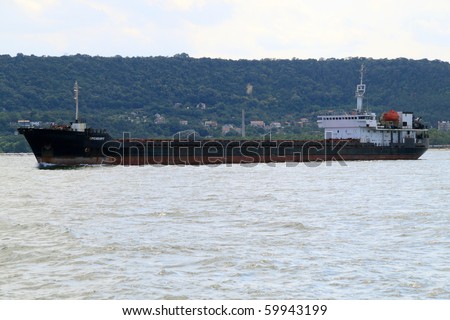 VARNA, BULGARIA - AUGUST 23: Cargo ship ORENBURG (Year Built: 1994, Flag: Russia, DeadWeight: 5885 t) sails away into open sea after a short stay in Port of Varna on August 23, 2010 in Varna, Bulgaria.