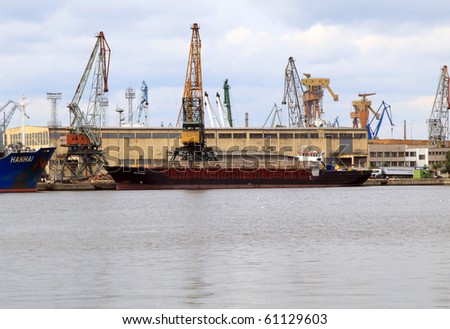 VARNA, BULGARIA - SEPTEMBER 05: Cargo ship MEGANISI (Year Built: 1986, DeadWeight: 2014 t, Flag: Malta) is loaded with 1300 t of logs in Port of Varna-East on September 05, 2010 in Varna, Bulgaria.