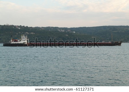 VARNA, BULGARIA - SEPTEMBER 13: Cargo ship ALCOR (Year Built: 1975, Flag: Cambodia) sails into Port of Varna-West to deliver  4700 tons of coal on September 13, 2010 in Varna, Bulgaria.