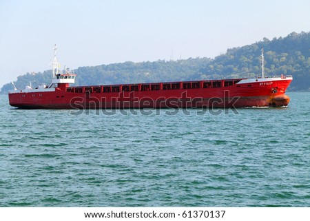 VARNA, BULGARIA - SEPTEMBER 19: Cargo ship ST FILIP (Year Built: 1980, Flag: Tanzania) sails into Port of Varna-West to load 2012 tons of heavy soda on September 19, 2010 in Varna, Bulgaria.