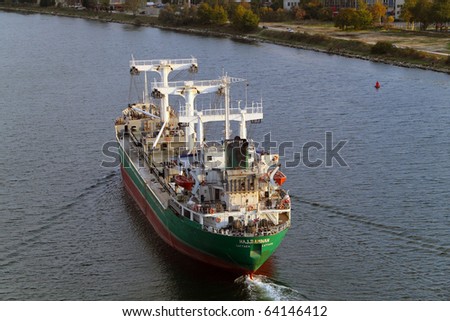 VARNA, BULGARIA - OCTOBER 31: Cargo ship HAJJI AMNAH (Flag: Syria) sails away into open sea after delivering 7700 t of phosphorite to Varna-West Port on October 31, 2010 in Varna, Bulgaria.