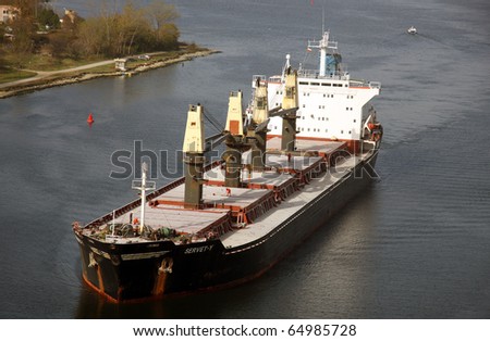 VARNA, BULGARIA - NOVEMBER 11: Cargo ship SERVET-Y (Flag: Turkey) sails  into open sea after being loaded with 30 000 tonnes of triple superphosphate on November 11, 2010 in Varna, Bulgaria.