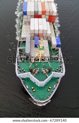 VARNA, BULGARIA - DECEMBER 14: Cargo ship WARNOW VAQUITA (Year Built: 2008) sails into open sea on December 14, 2010 in Varna, Bulgaria. Ship`s next destination is Constanta, Romania.