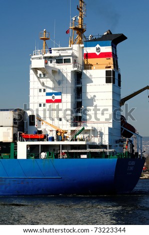 VARNA, BULGARIA - MARCH 14: Cargo ship HOLANDIA (Flag: Antigua Barbuda, Year Built: 2000) sails into Port of Varna-West to be loaded with containers on March 14, 2011 in Varna, Bulgaria.