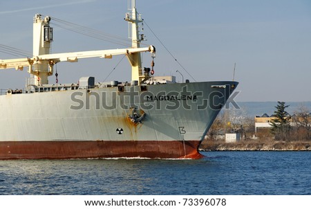 VARNA, BULGARIA - MARCH 14: Cargo ship MAGDALENA (Year Built: 1988, Dead Weight: 13864 t) is sailing away into open sea after a short stay in Varna-west port on March 14, 2011 in Varna, Bulgaria