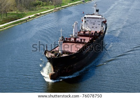 VARNA, BULGARIA - APR 22: Cargo ship LINDEN (Year Built: 1977, Flag: Moldova) sails away into open sea after a short stay in Varna-west port on April 22, 2011 in Varna, Bulgaria.