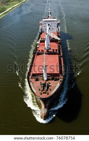 VARNA, BULGARIA - APR 22: Cargo ship LINDEN (Year Built: 1977, Flag: Moldova) sails away into open sea after a short stay in Varna-west port on April 22, 2011 in Varna, Bulgaria.