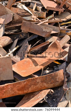 Scrap metal piled in port docks for export.