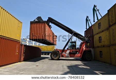 VARNA, BULGARIA - MAY 12: Forklift truck moves containers on May 12, 2011 in Varna, Bulgaria. The market share of processed containers in Port of Varna in the Black Sea region had fallen below 6 %.