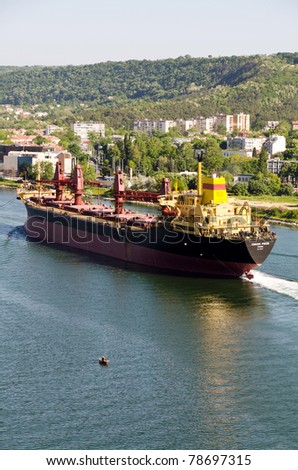 VARNA, BULGARIA - MAY 28: Cargo ship SVILEN RUSSEV (Year Built: 1982, Flag: Bulgaria, DeadWeight: 39408 ton) sails away into open sea after a major revamp work on May 28, 2011 in Varna, Bulgaria