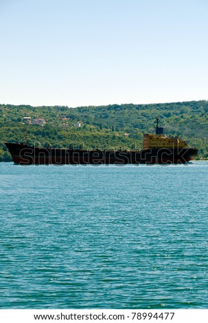 VARNA, BULGARIA - JUNE 07: Cargo ship ZAGORE (Year Built: 1978, Flag: Comoros) sails away into open sea after a short stay in Varna-west port on June 07, 2011 in Varna, Bulgaria.