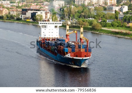 VARNA, BULGARIA - MAY 13: Cargo ship ALEXANDER SIBUM (Flag: Antigua Barbuda, Year Built: 2006) sails to Port of Varna-West to load containers on May 13, 2011 in Varna, Bulgaria.