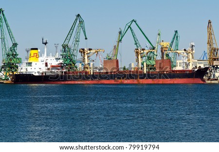 VARNA, BULGARIA - JUNE 24: Cargo ship PATRIOT R (Built: 1981, Flag: St Vincent Grenadines) is loaded with 13200 t of barley in Port of Varna-East on June 24, 2011 in Varna, Bulgaria.