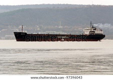 VARNA, BULGARIA - MARCH 11: Cargo ship BATYA (ex DURRINGTON), Year Built: 1981, Flag: Bulgaria sails away after a short stay at MTG-DOLPHIN for conversion work on March 11, 2011 in Varna, Bulgaria.