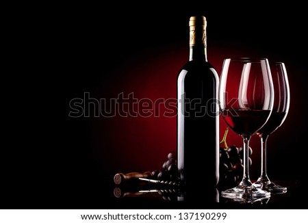 two glasses of wine, bottle, grapes and corkscrew