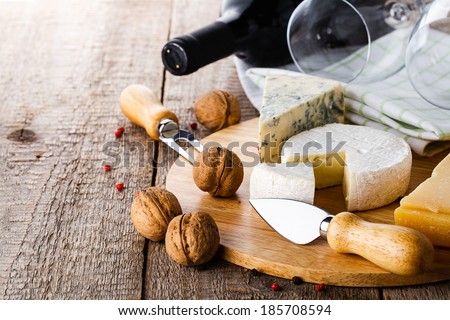 served cheese and wine on old wooden table