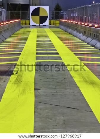 Straight and narrow and yellow -- indoor test track for attendees of auto show