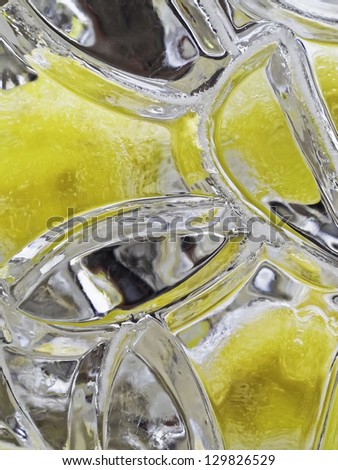 Dream on a hot summer day: Lemons frozen in a block of ice
