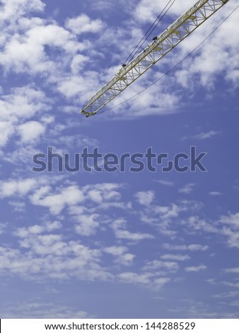 Concepts of beginnings and elevated creation: End of construction crane high in the sky, with copy space for dropping in your graphics or text