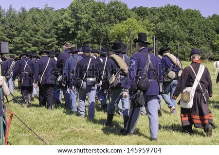 WAUCONDA, ILLINOIS/USA - JULY 13: American Civil War (1861-1865) reenactment on July 13, 2013, in Wauconda, Illinois. Union infantry march toward camp after a mock battle.