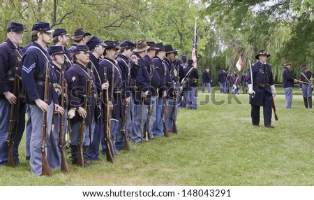 LOMBARD, ILLINOIS/USA - JULY 27: American Civil War (1861-1865) reenactment on July 27, 2013, in Lombard, IL. Union soldiers, actors all, stand ready to march toward a mock battle.
