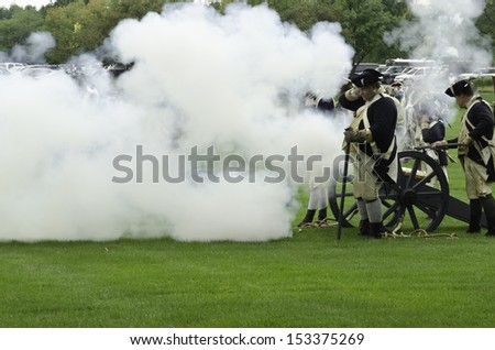 WHEATON, ILLINOIS/USA - SEPTEMBER 7: American Revolutionary War (1775-1783) reenactment on September 7, 2013, in Wheaton, IL. Cannon smoke obscures actors dressed as soldiers of the Continental Army.