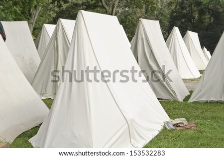 White tents in military encampment at reenactment of American Revolutionary War (1775-1783)