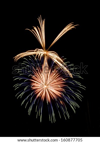 Spherical burst of red and blue fireworks, with a burst of silver flares on top