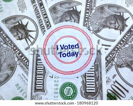 It pays to vote: Proclamatory sticker on a pile of fake million-dollar bills (play money)