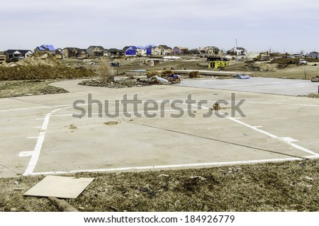 WASHINGTON, ILLINOIS, USA - MARCH 31, 2014: A concrete driveway with the outline of a basketball court is all that remains of a house destroyed by a tornado on November 17, 2013.
