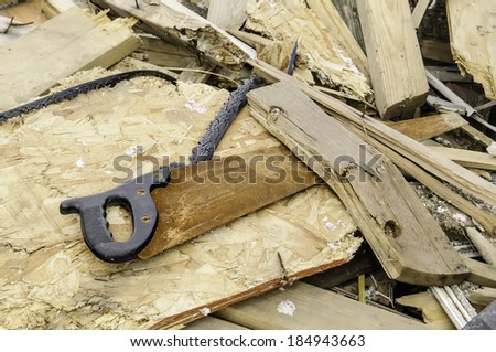 A rusty handsaw lies amid broken boards and other debris four months after a tornado devastated the surrounding neighborhood in Washington, Illinois, USA