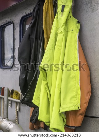 Heavy weather ahead: Rain gear hanging together aboard a commercial fishing boat