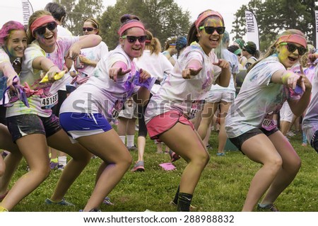 LAKE ZURICH, ILLINOIS, USA - June 20, 2015: Five girls dance happily together before a 5K \
