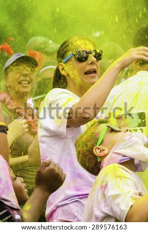 LAKE ZURICH, ILLINOIS, USA - June 20, 2015: It\'s pouring yellow as celebrants begin a 5K \