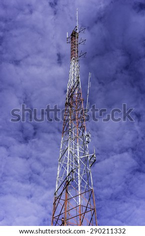 Tall infrastructure that symbolizes many themes of interdependence: Top of steel lattice tower for wireless communication, designed to withstand strong wind, in a small city in the American Midwest