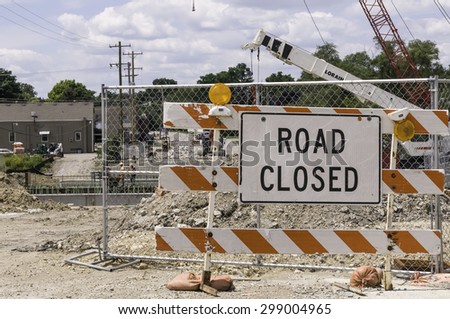 WARRENVILLE, IL, USA - July 22, 2015: Road closure means detours for motorists and pedestrians during a civil engineering project to realign part of a river and replace an old bridge with a new one.