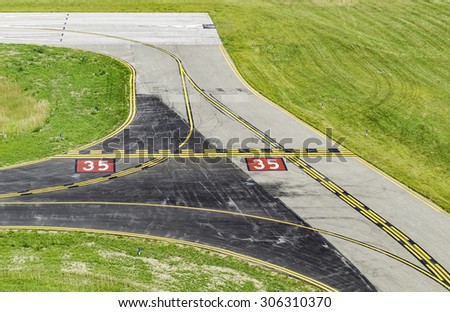 Aviation safety at a glance: Centerlines and other navigational markings by corner of runway at a small civilian airport