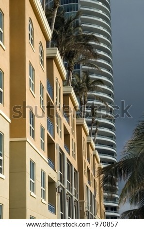 Low-rise and high-rise condominiums sunlit on rainy day