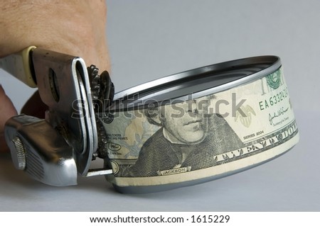 Man\'s hand using can opener to open a can of money