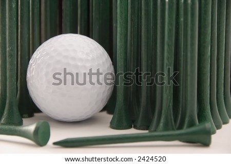Green tees standing like tall grass around white golf ball