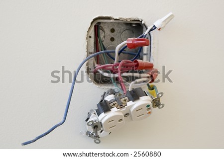 Electrical outlet during installation in office wall