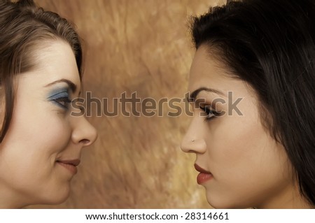 Face-off: two pretty young brunettes look at each other