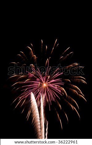 Fireworks burst with pink streaks inside embers from previous explosion, with feathery white rocket trails