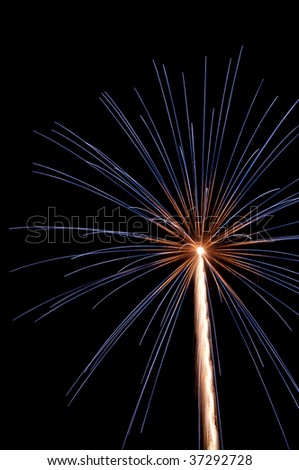 White-hot rocket trail to burst of fireworks with deep blue streaks outside reddish interior