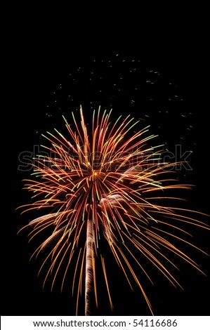 Overlapping bursts of reddish yellow fireworks, one or two with white streaks, near cloud of embers