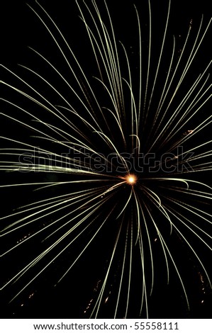 Full-frame burst of fireworks with yellowish-red core of explosion
