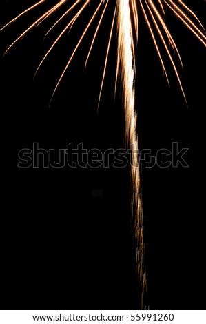 Implied (off-camera) burst of fireworks above bright rocket trail