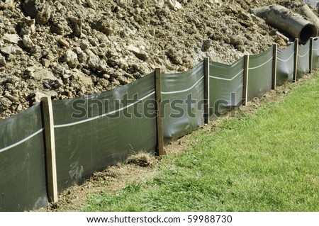 Temporary retaining wall of green plastic on construction site