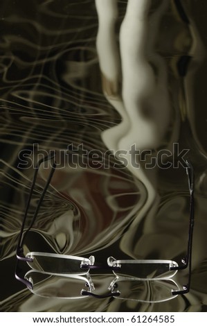 Illusion and reality: Reading glasses on reflective surface with distorted leading lines