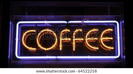Neon sign in window of store: COFFEE